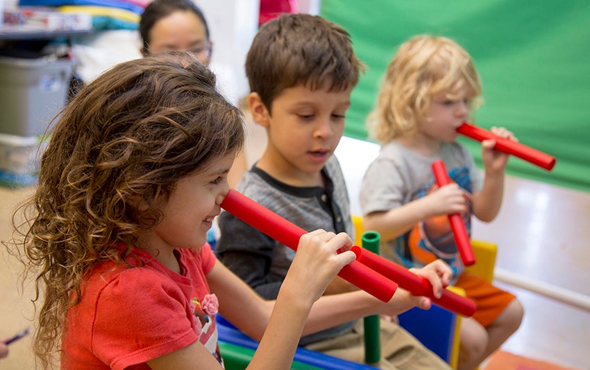 photo of a group of preschool children playing in a classroom