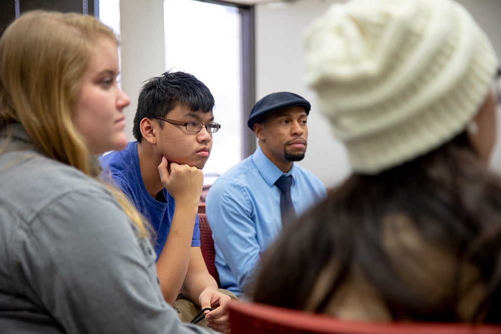 Students concentrating on something to the right of the image