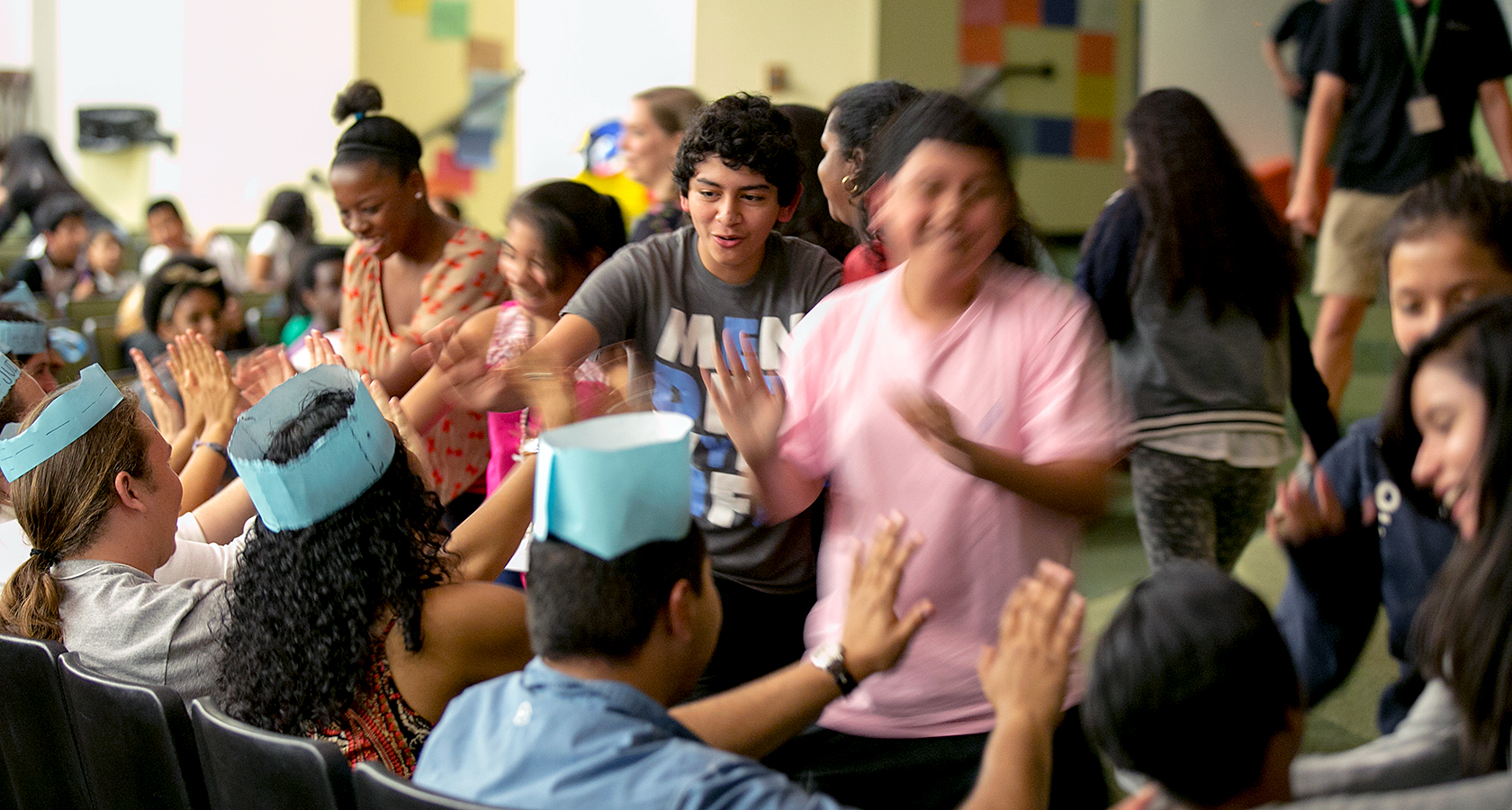 Breakthrough Austin students start their day by giving each other high fives. 