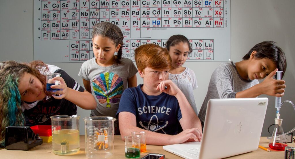 A group of middle school students collaborate on a science project. 