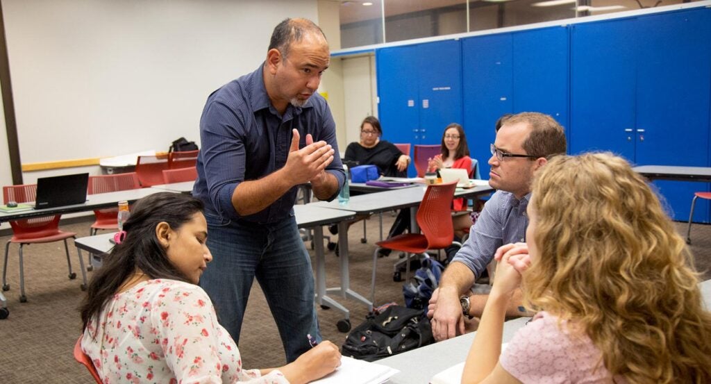 Graduate students collaborate on a project.