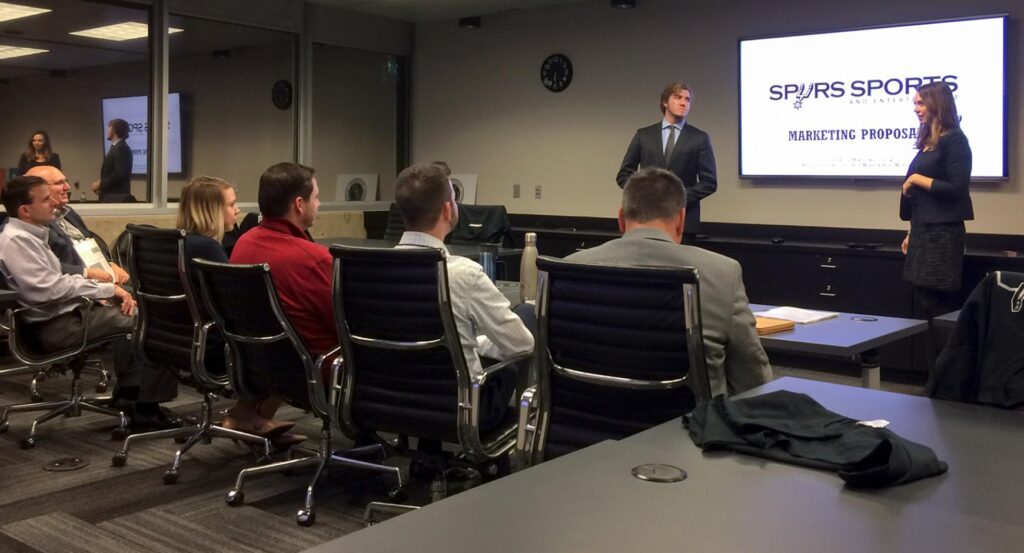 Two Sport Management graduate students give a presentation to the San Antonio Spurs management team.