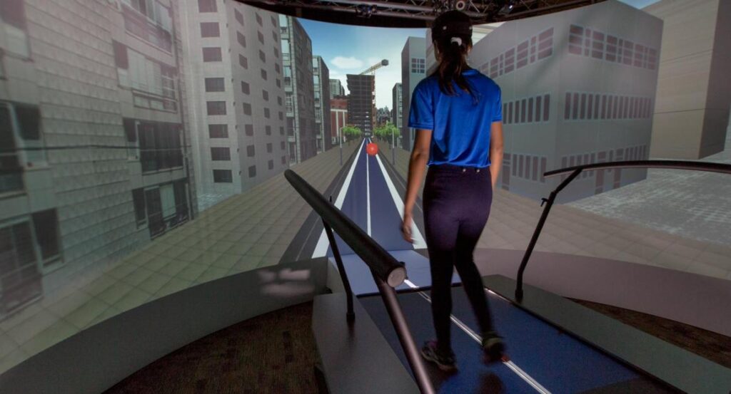 A woman on a treadmill in front of a simulated green screen environment