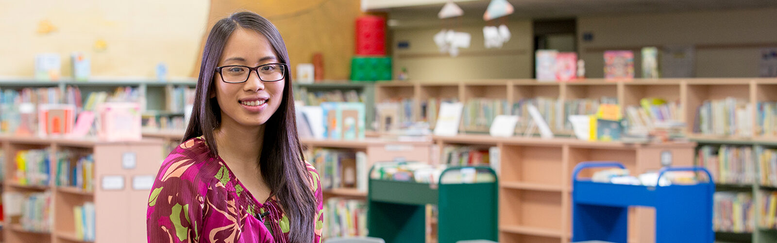 A student teacher poses in her school's library.