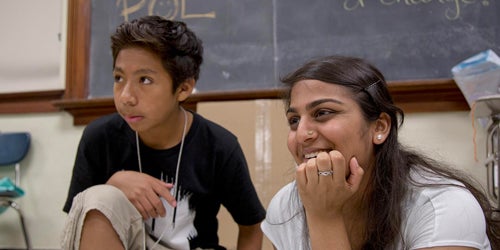 A teacher works with one of her students. 