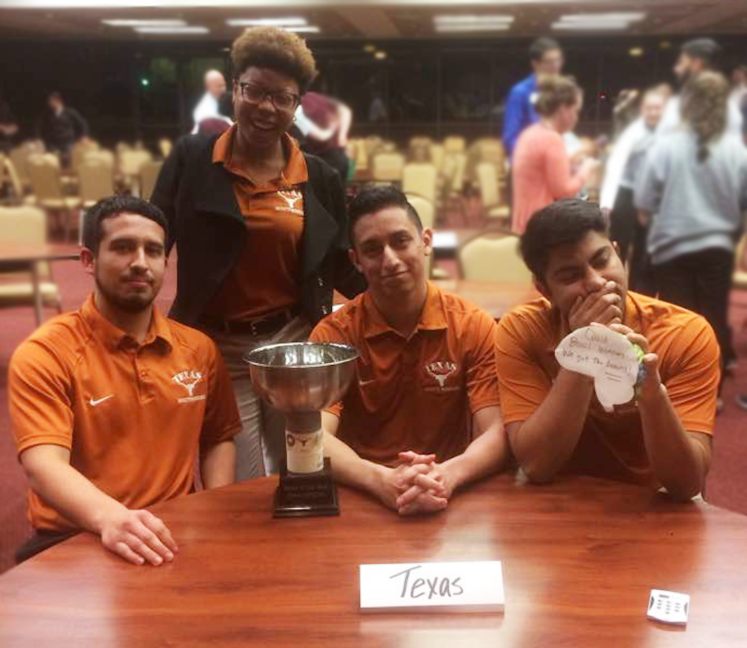 Four UT athletic training students with their trophy for SWATA quiz bowl