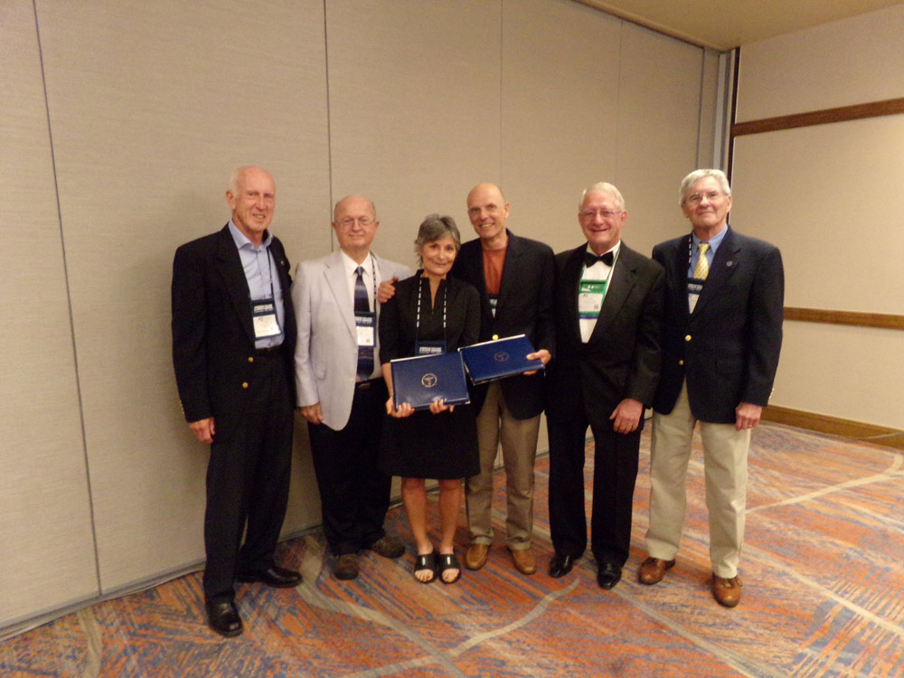 Dixie and Phil Stanforth standing with past presidents of the ACSM