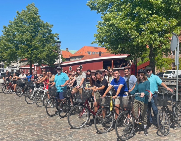 A group of students prepare to ride bikes through Copenhagen