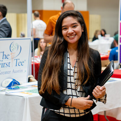 A young woman attends a career fair