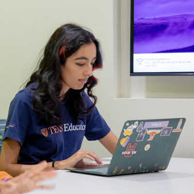 A young woman works on her laptop.