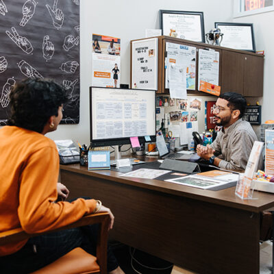 An academic advisor meets with a student.