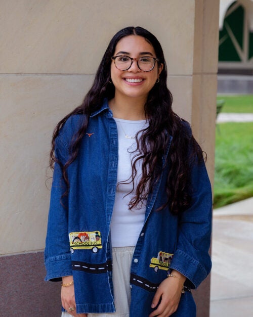 Afsaneh Masoumi in a blue jacket standing and smiling.
