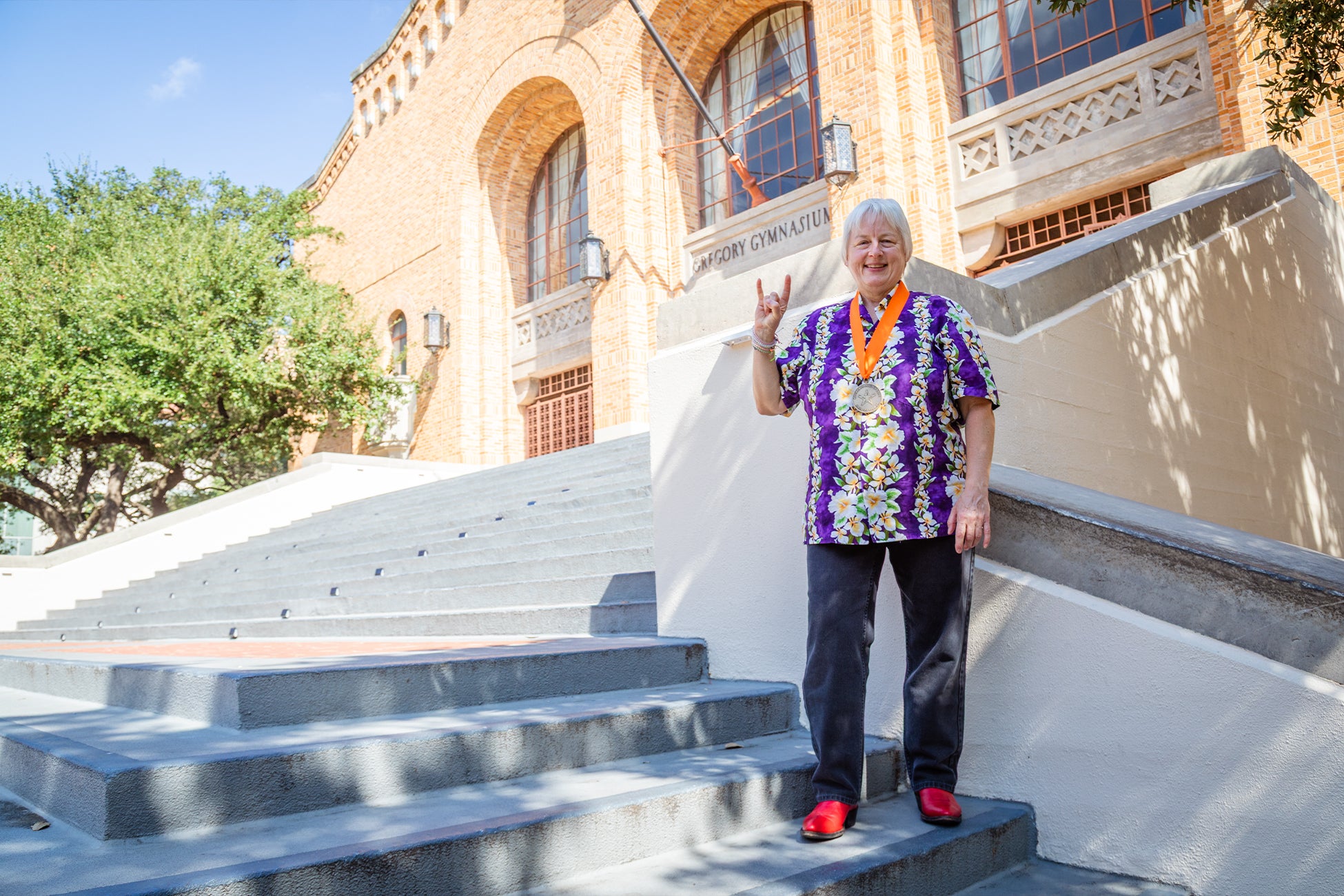Tara Brady is standing on the steps of UT Austin Gregory Gym.